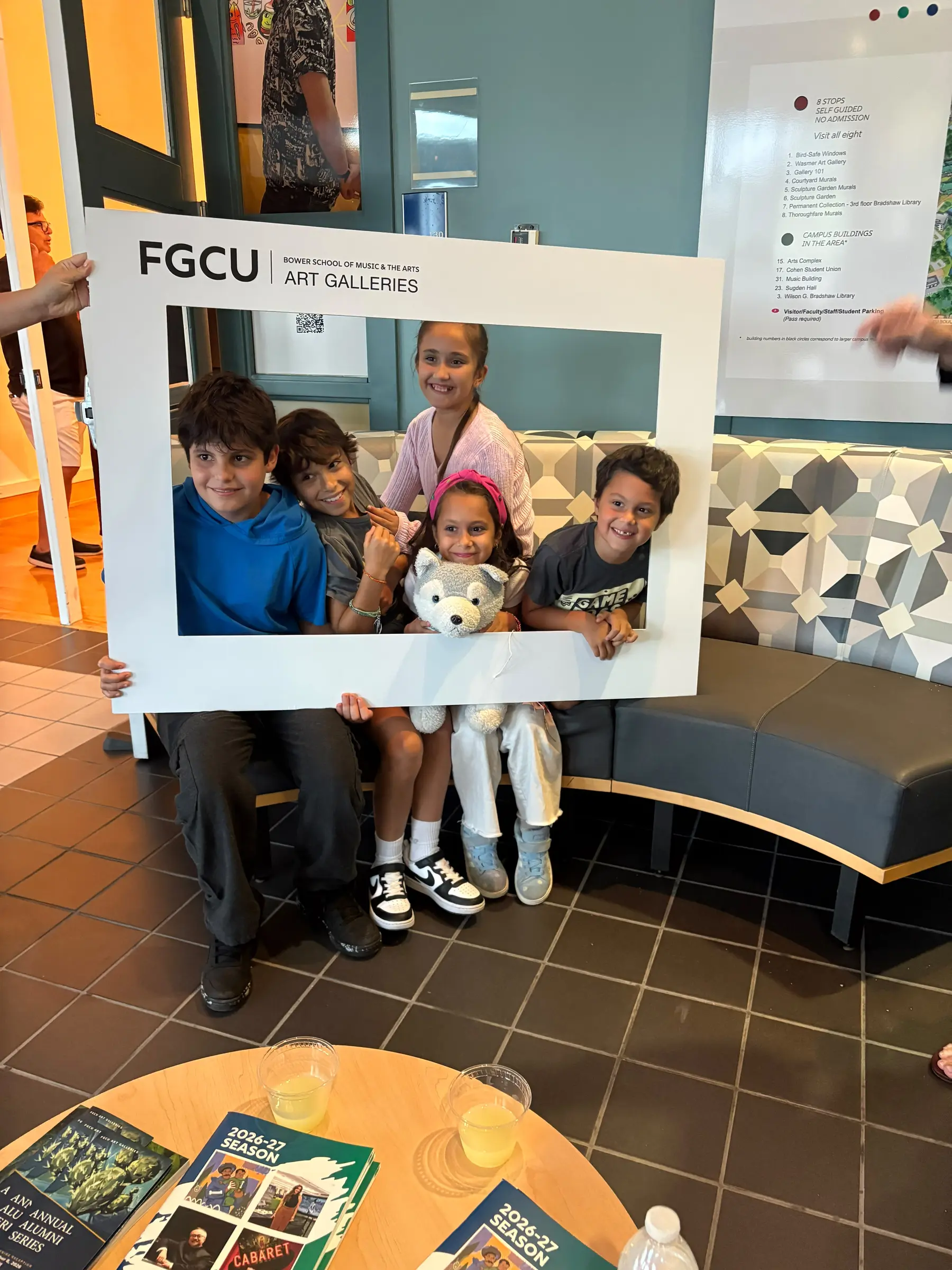 Young gallery visitors posing inside an FGCU Art Galleries frame