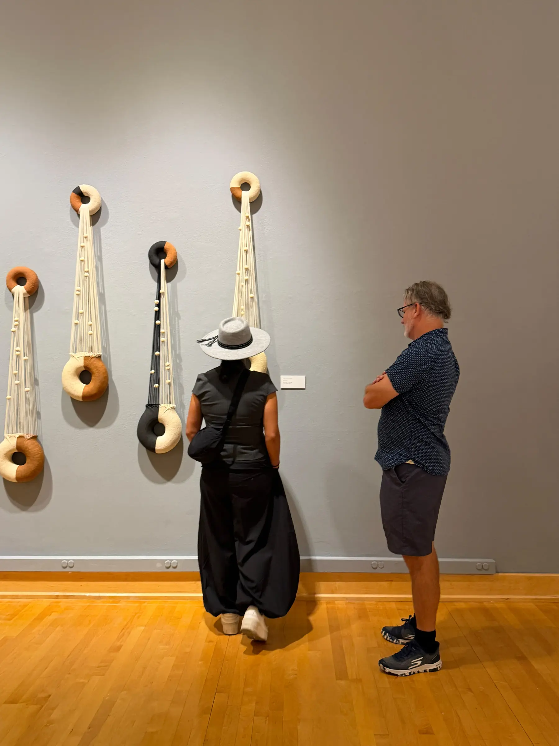 Visitors studying the illuminated ceramic and fiber lamps