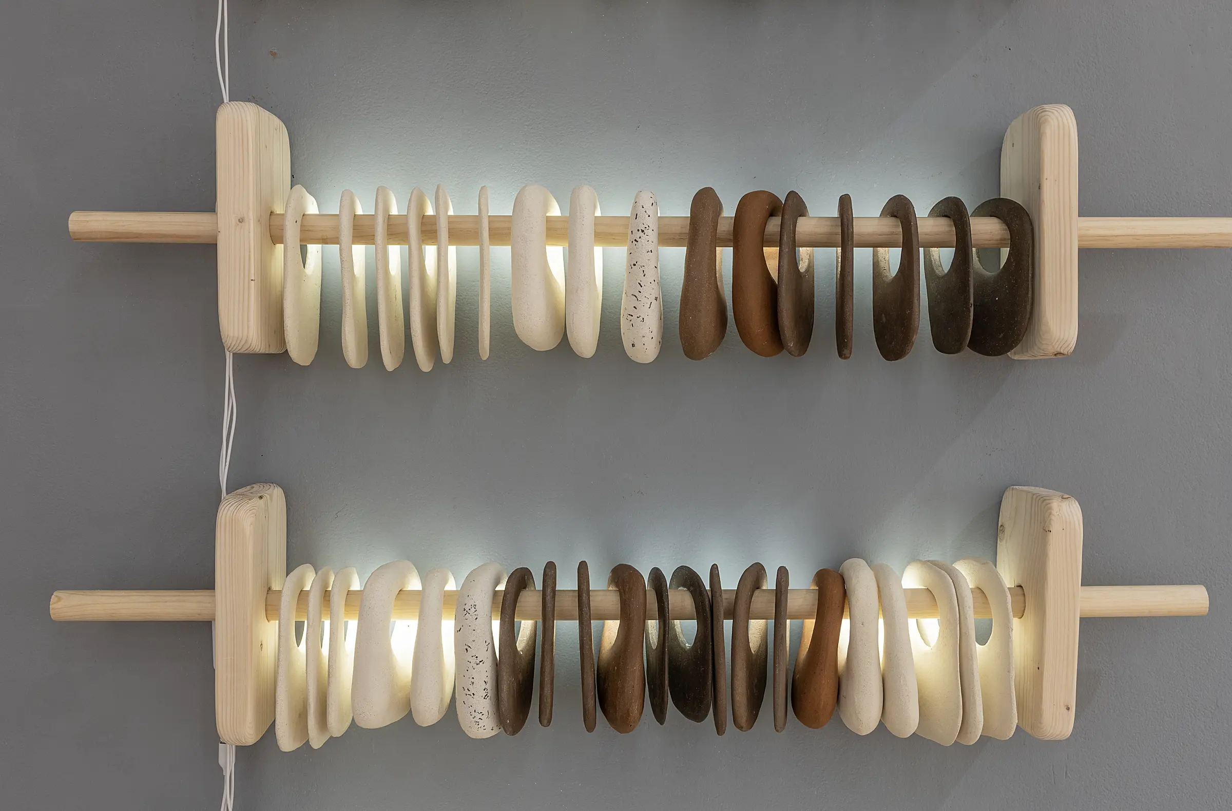 Detail of two illuminated rows of white and brown ceramic components