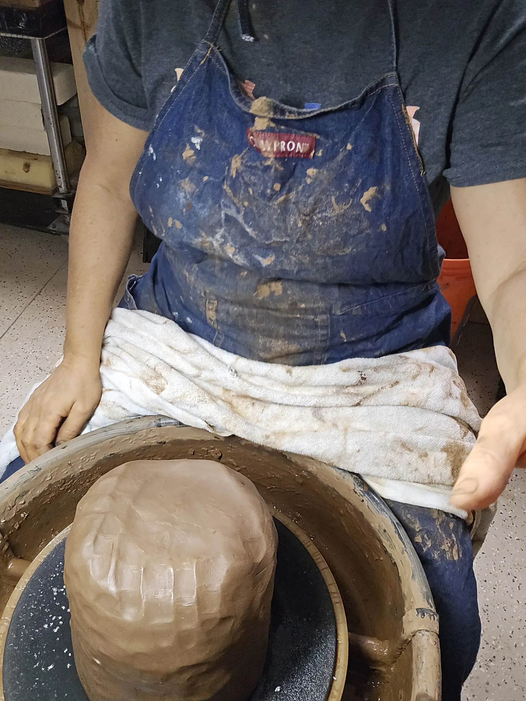 Maria shaping a rounded clay vessel from the inside