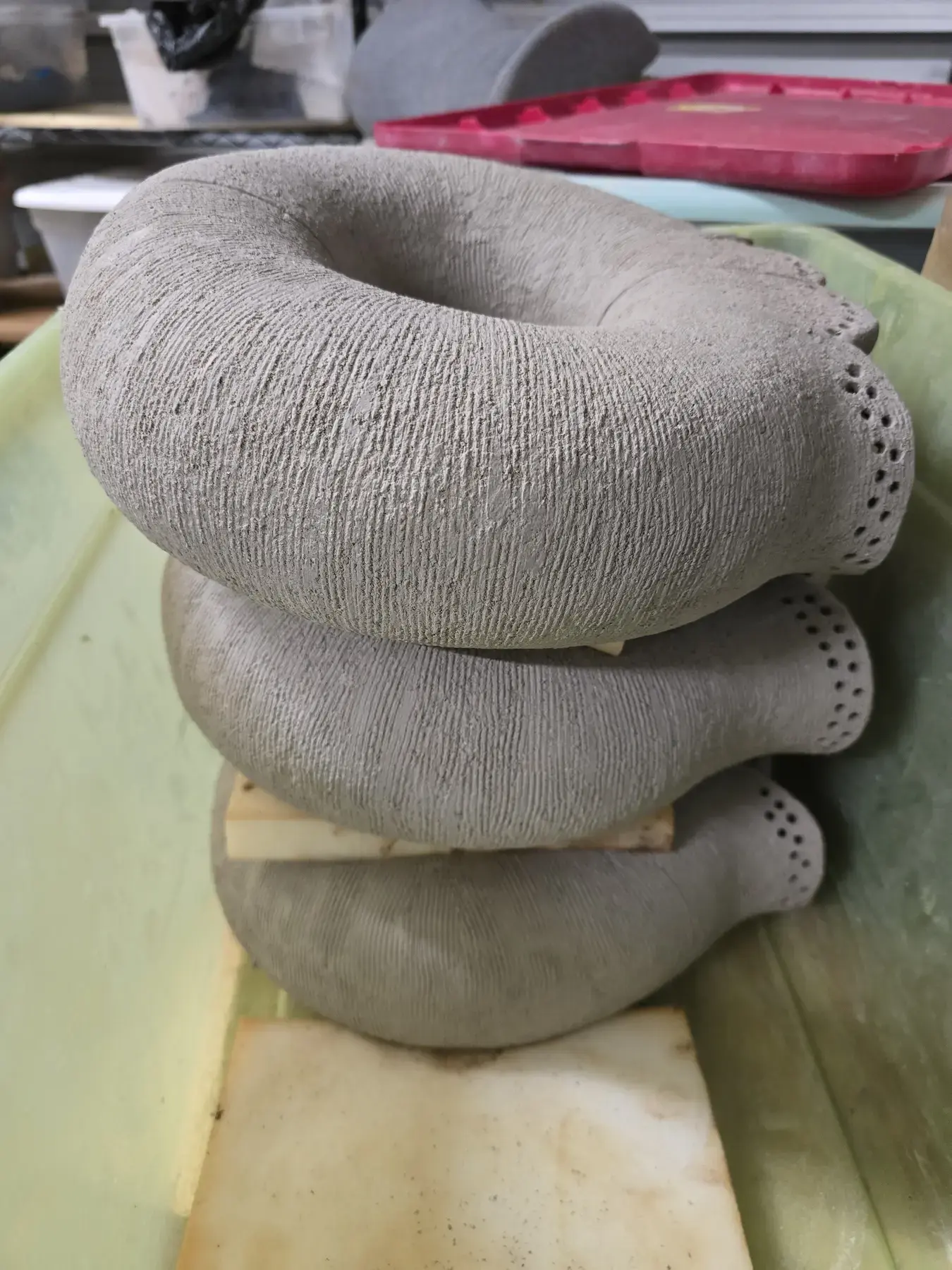 Stacked rounded clay forms with textured surfaces